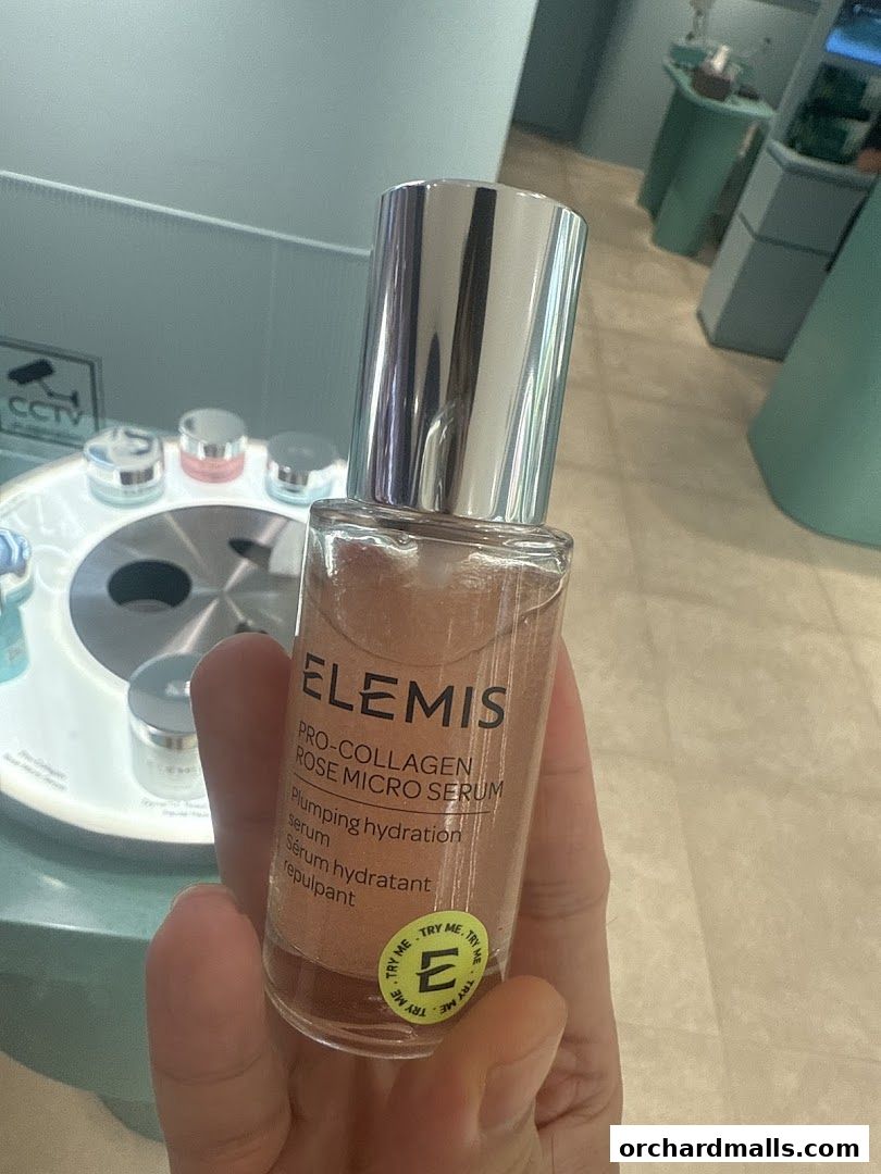 A hand holds a bottle of Elemis Pro-Collagen Rose Micro Serum with a 'Try Me' sticker.