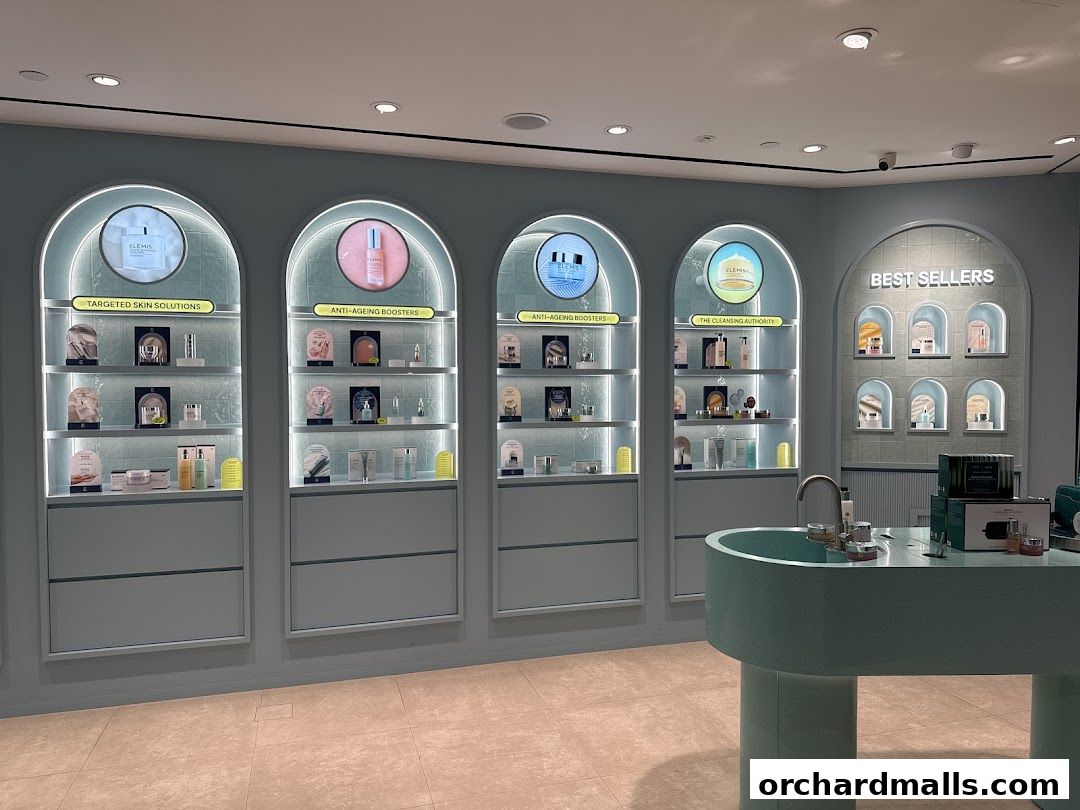 Interior of an Elemis London shop showcasing skincare products on illuminated shelves.