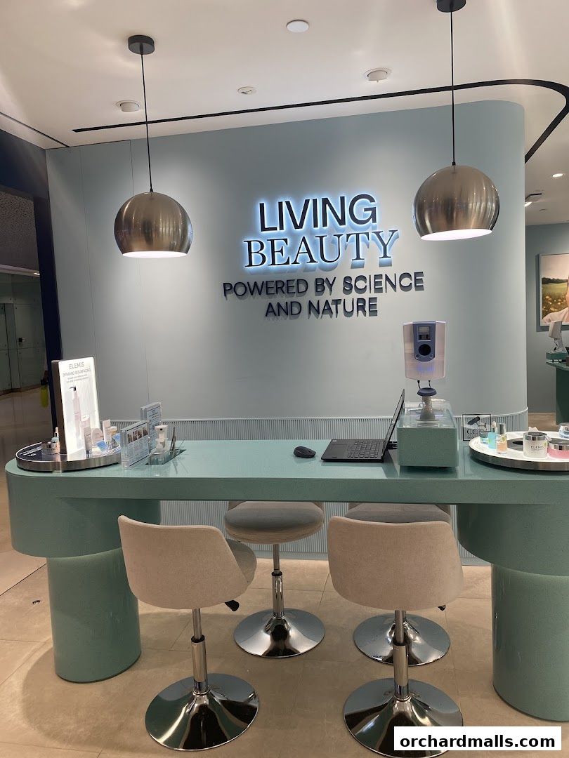 Elemis London shop interior with a reception desk, chairs, and illuminated signage.