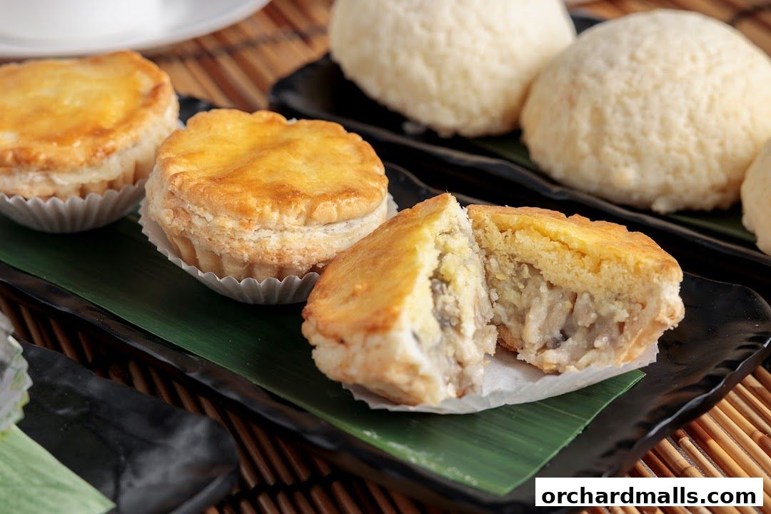 Close-up of golden-brown baked pastries filled with savory ingredients.