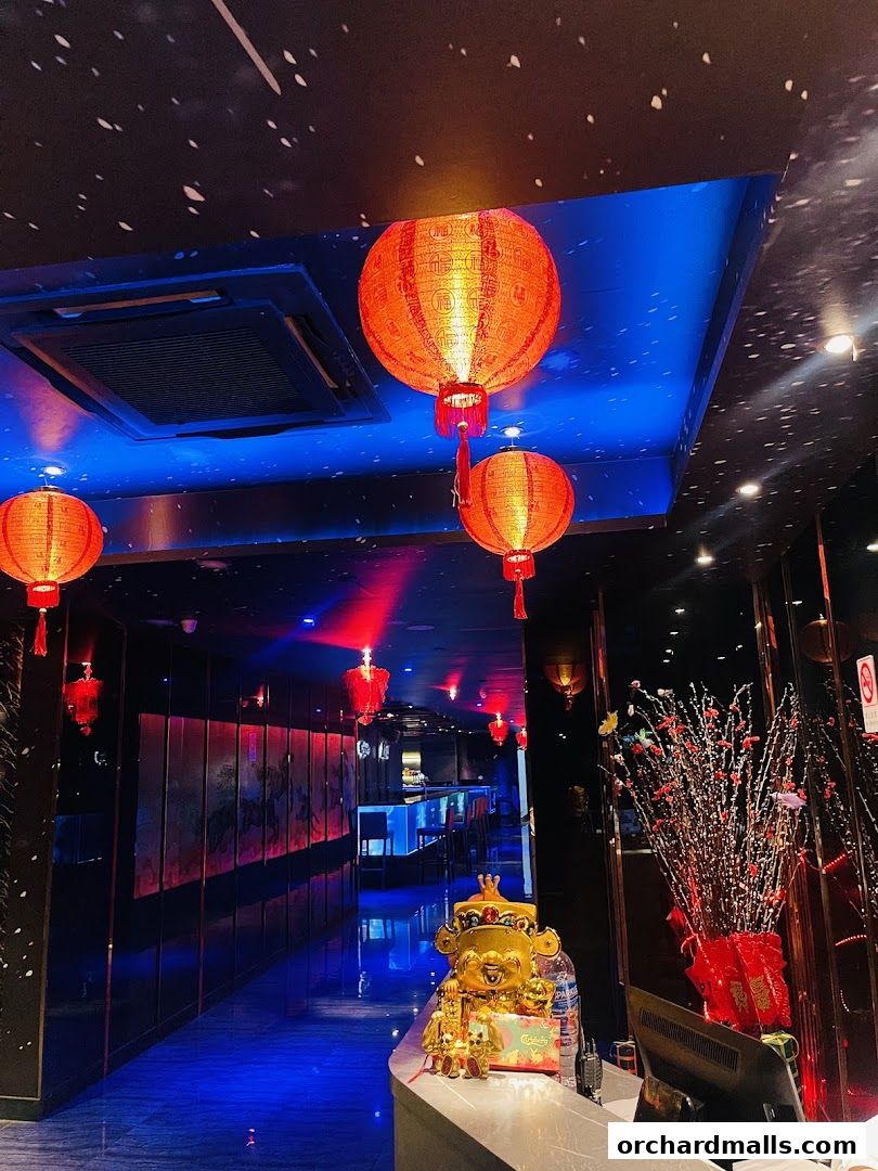 Interior of Empire KTV with red lanterns, blue lighting, and decorative elements.