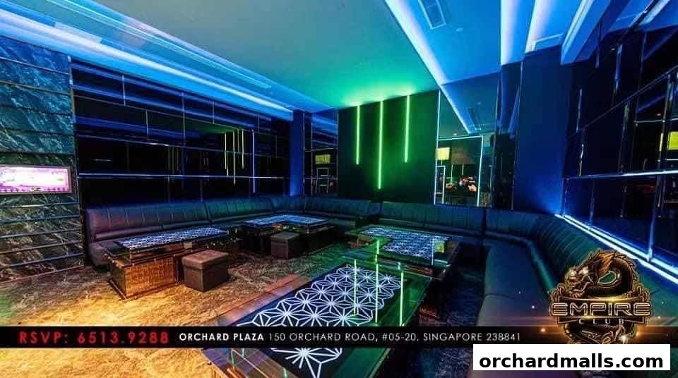 Luxurious KTV room with plush seating, modern tables, and vibrant neon lighting.