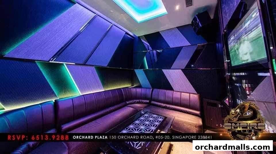 Luxurious KTV room with plush seating, modern lighting, and a large screen.