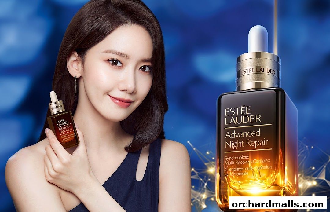A woman holds an Estée Lauder Advanced Night Repair serum bottle next to a larger bottle.