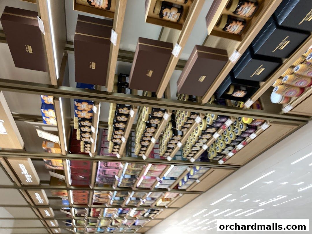 Shelves stocked with various gift boxes and packaged goods in a retail store.