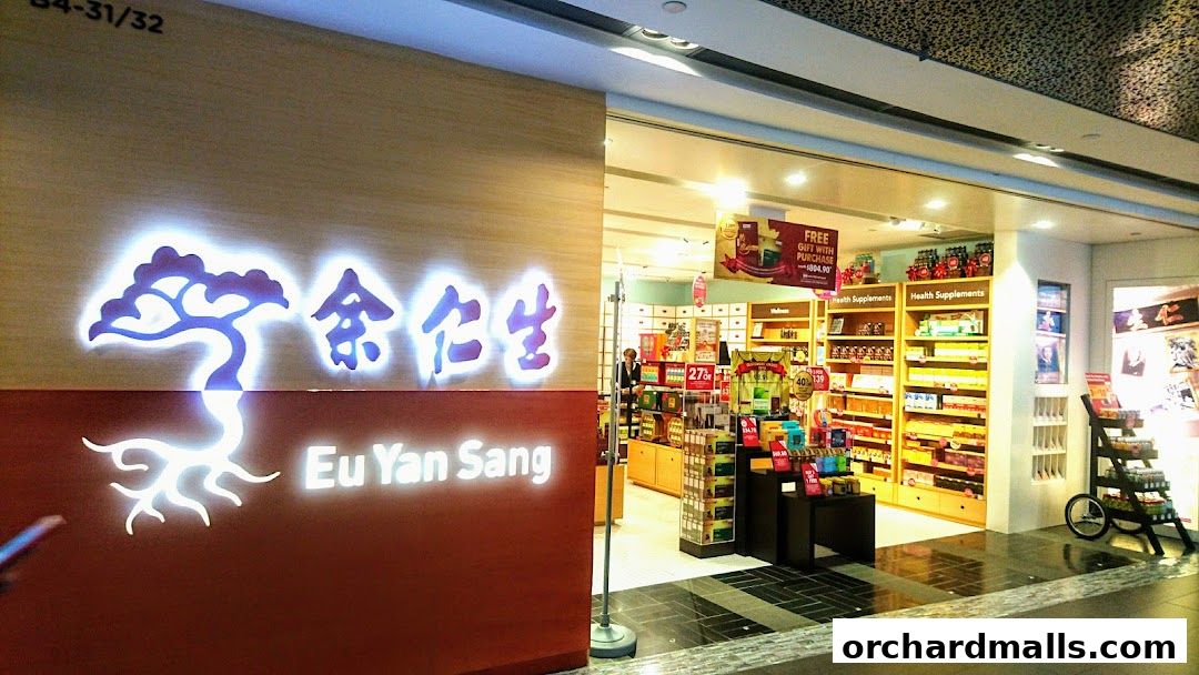 The exterior of a Eu Yan Sang shop, showcasing its illuminated signage and well-stocked interior.