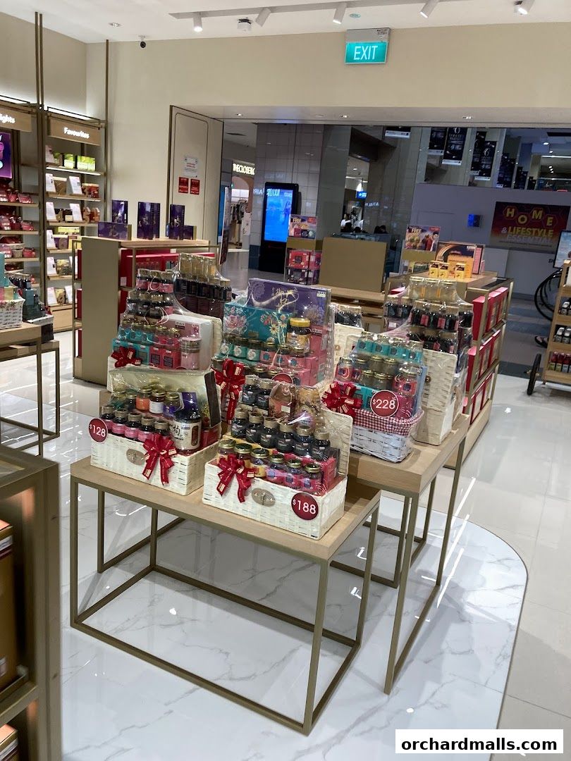 Gift baskets filled with various products are displayed on tables inside a retail store.