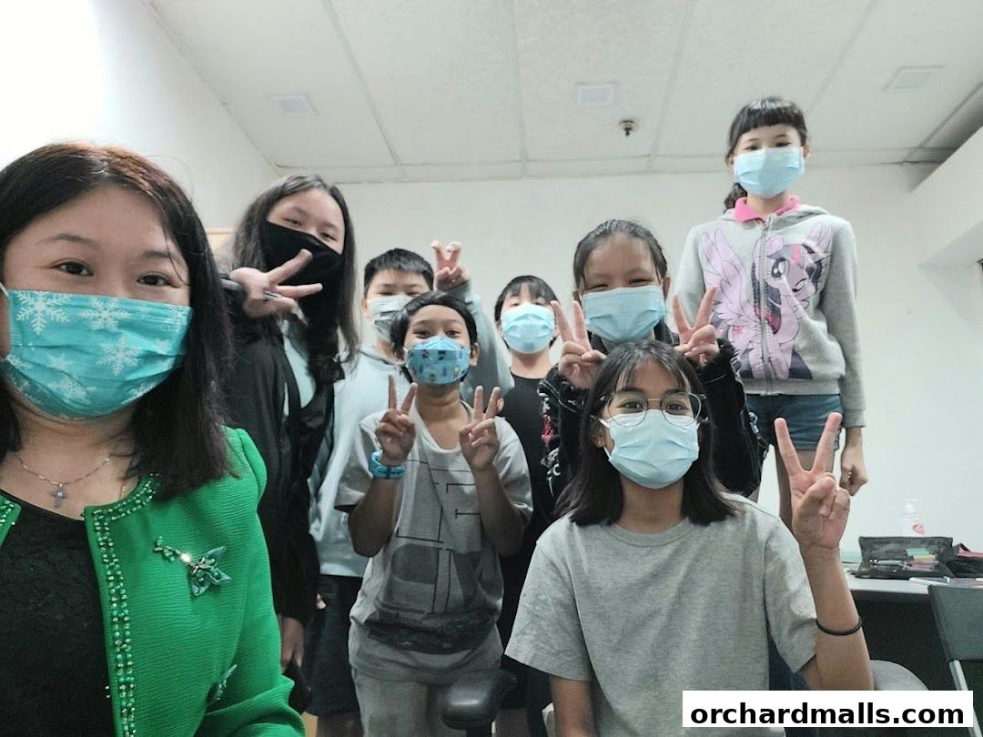 A group of students and a teacher wearing masks pose for a photo.