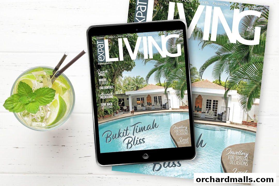 A tablet displays the cover of Expat Living magazine, featuring a resort-style pool and villas.