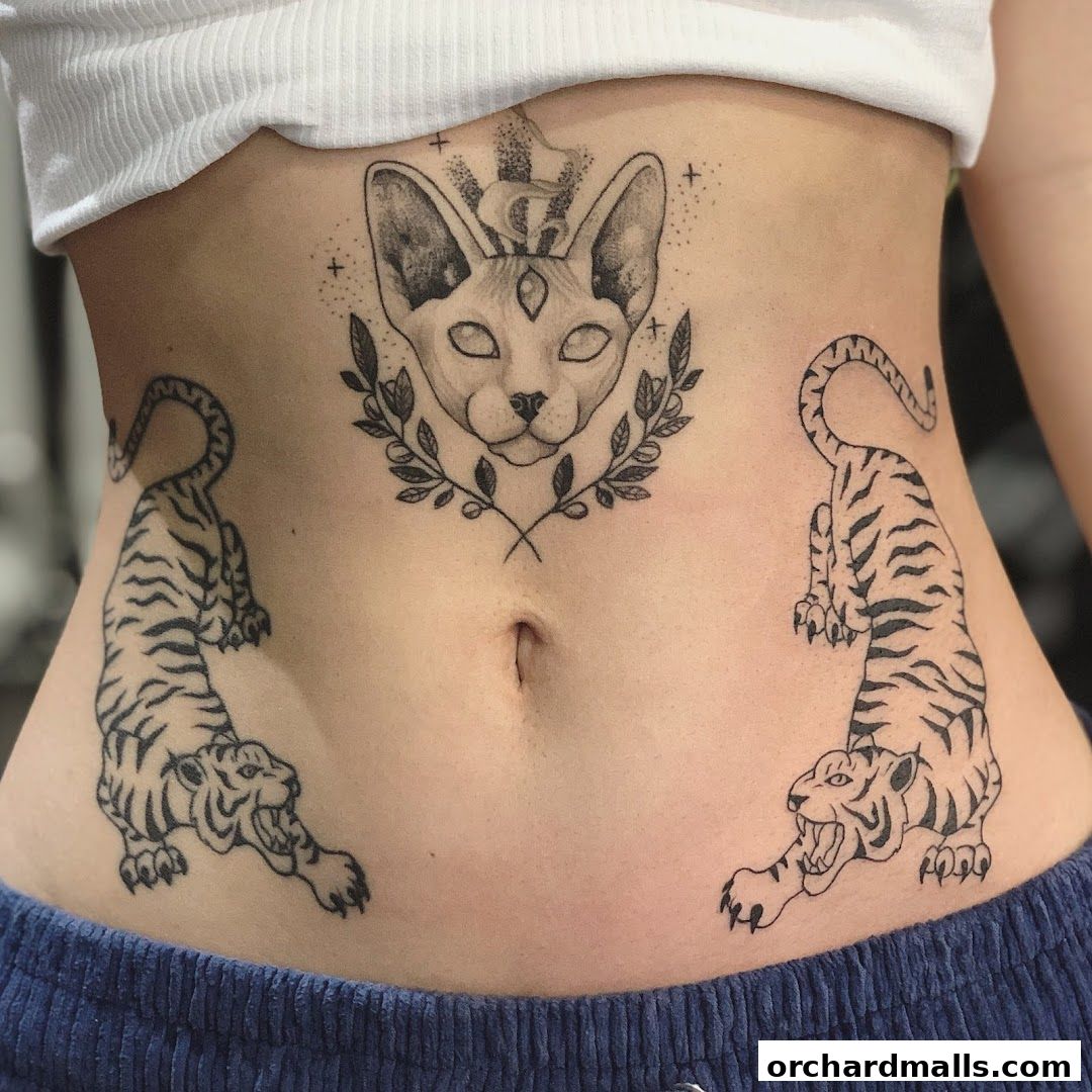 A person's torso displays intricate black ink tattoos of a cat head and two tigers.