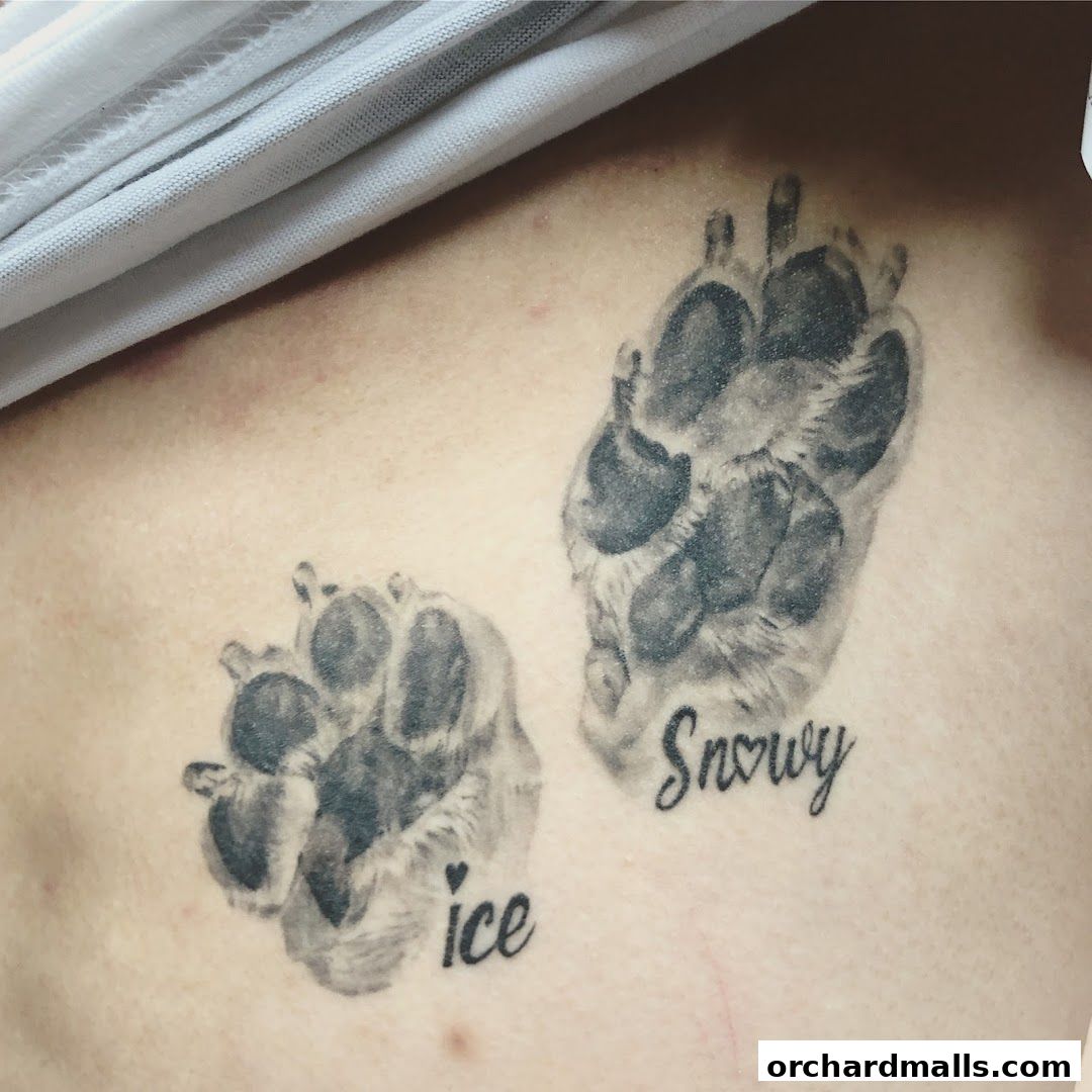 Realistic paw print tattoos with names 'Ice' and 'Snowy' on skin.
