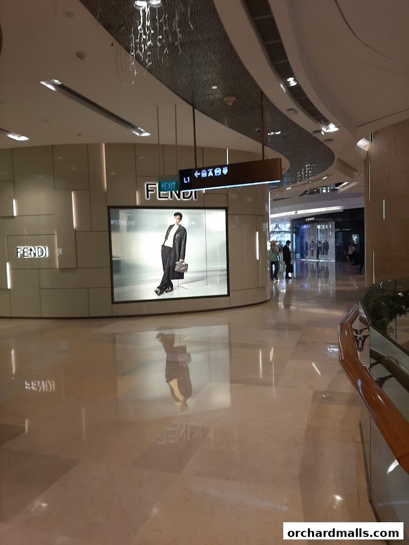The Fendi store entrance with a large display featuring a model in a stylish outfit.