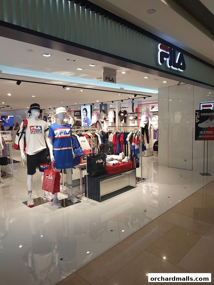 The FILA store showcases mannequins dressed in sportswear and a variety of apparel on display.
