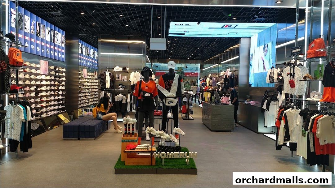 Interior view of a FILA store showcasing apparel, footwear, and accessories with mannequins and displays.