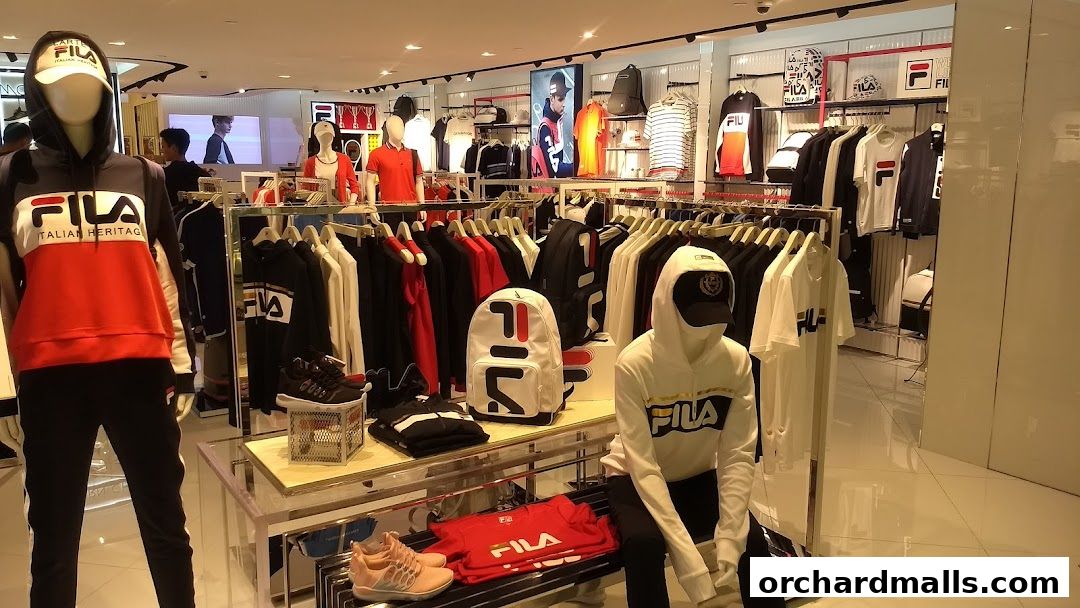 Interior view of a Fila store showcasing apparel and accessories on mannequins and racks.