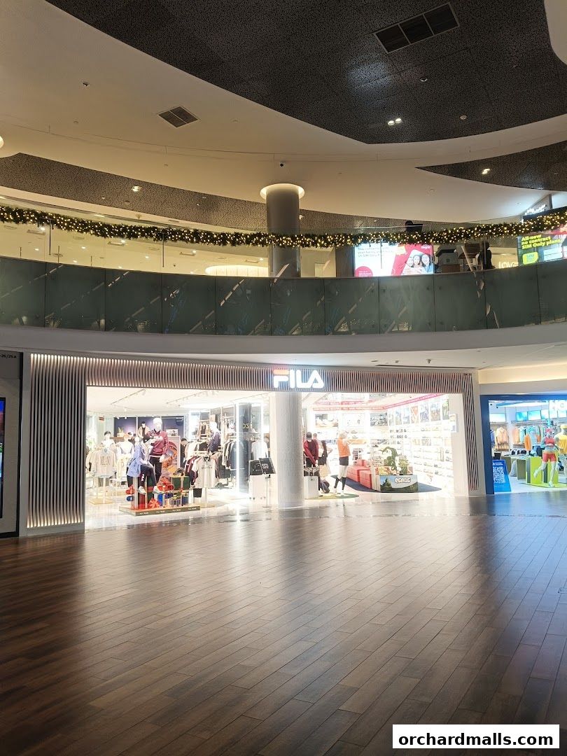 The FILA store entrance showcases apparel and accessories with mannequins displaying outfits.