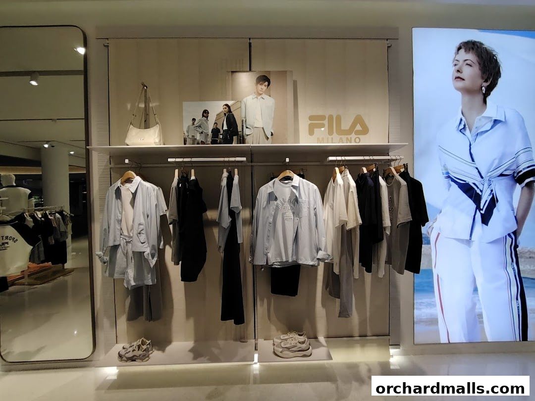 A Fila store display featuring clothing, accessories, and a large advertisement.