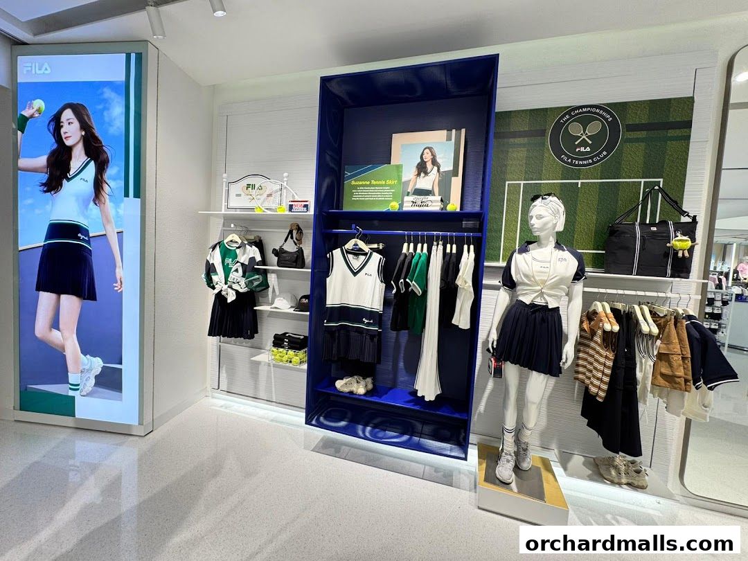 FILA store interior showcasing tennis-themed apparel and a mannequin.