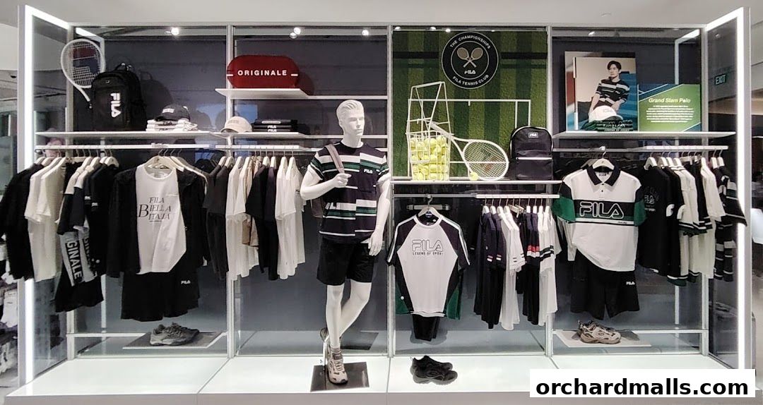FILA store display featuring tennis-themed apparel, a mannequin, and accessories.