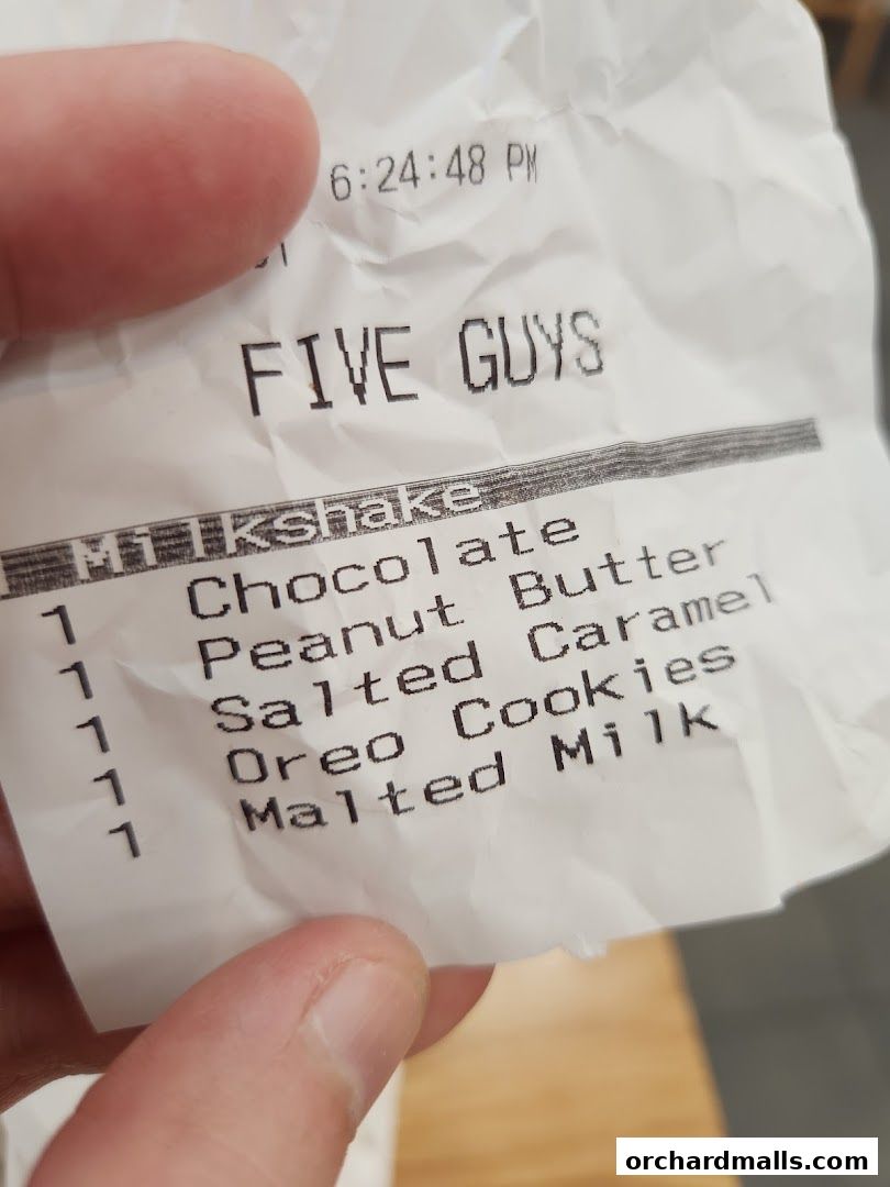 A receipt from Five Guys showing various milkshake flavors ordered.
