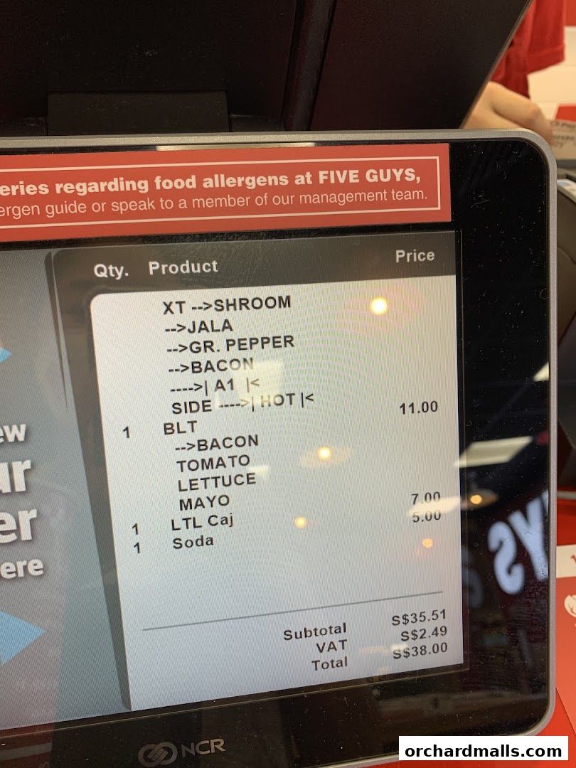 A close-up of a Five Guys order screen showing items and prices.