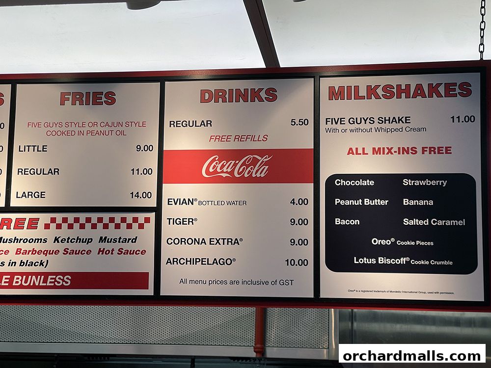 A menu board for Five Guys featuring fries, drinks, and milkshakes with prices.