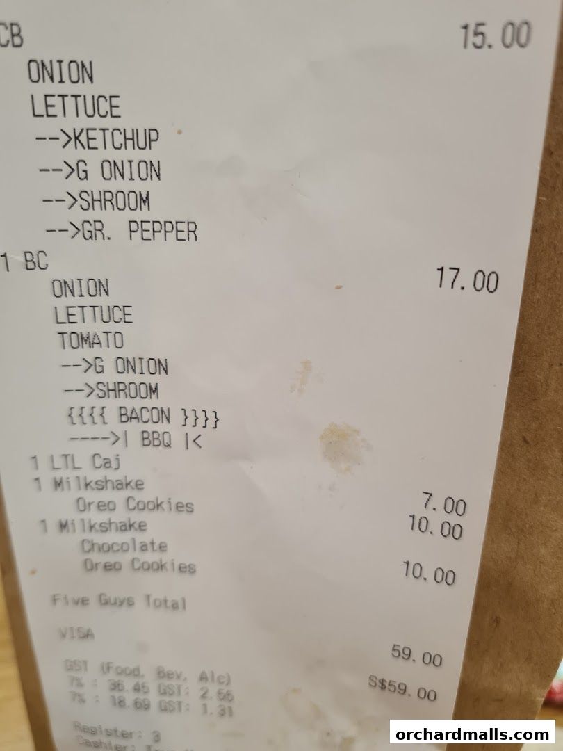A receipt from Five Guys showing burger customizations and milkshakes with prices.