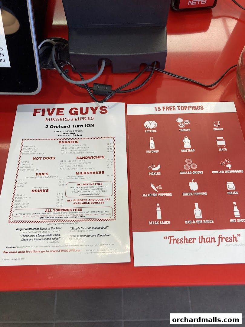 A menu from Five Guys Burgers and Fries showing burgers, hot dogs, fries, drinks, and free toppings.