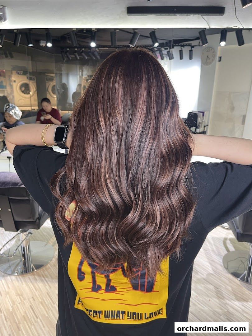 A person with beautifully styled, wavy brown hair with subtle highlights.