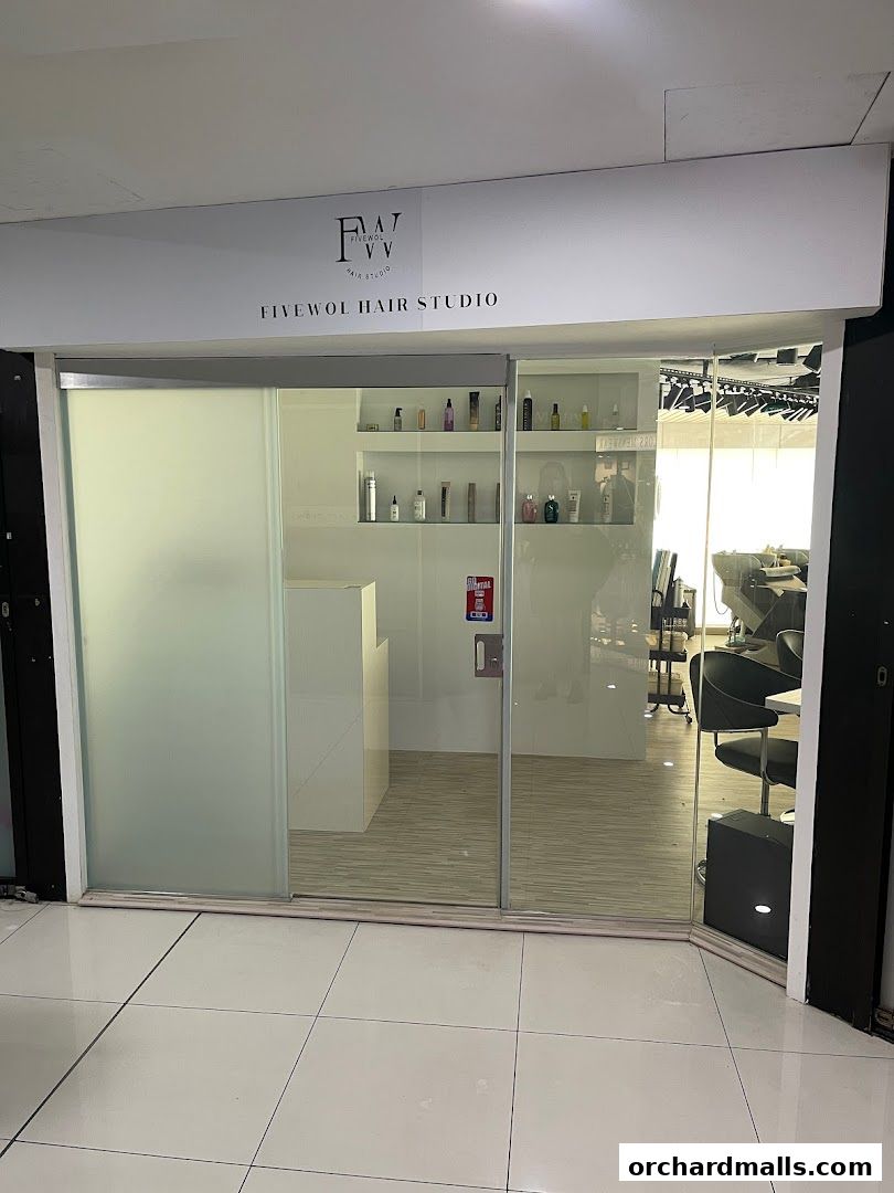 The exterior of FIVEWOL HAIR STUDIO, a modern hair salon with glass doors and signage.