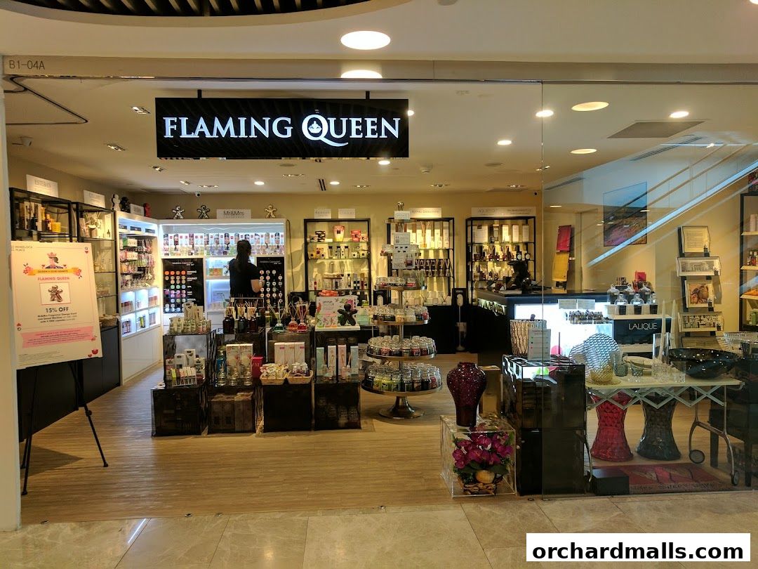 The exterior of the Flaming Queen shop, showcasing various home fragrance and decor items.