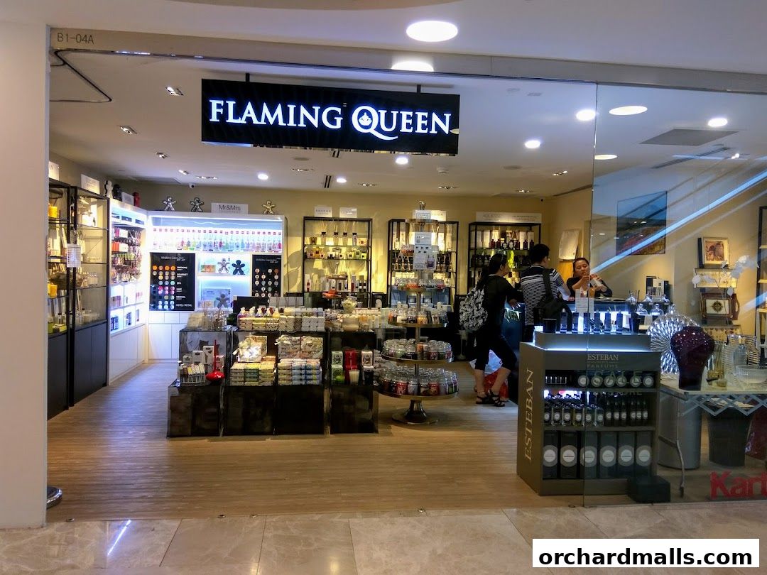 The exterior of the Flaming Queen shop, showcasing various perfumes and home fragrance products.