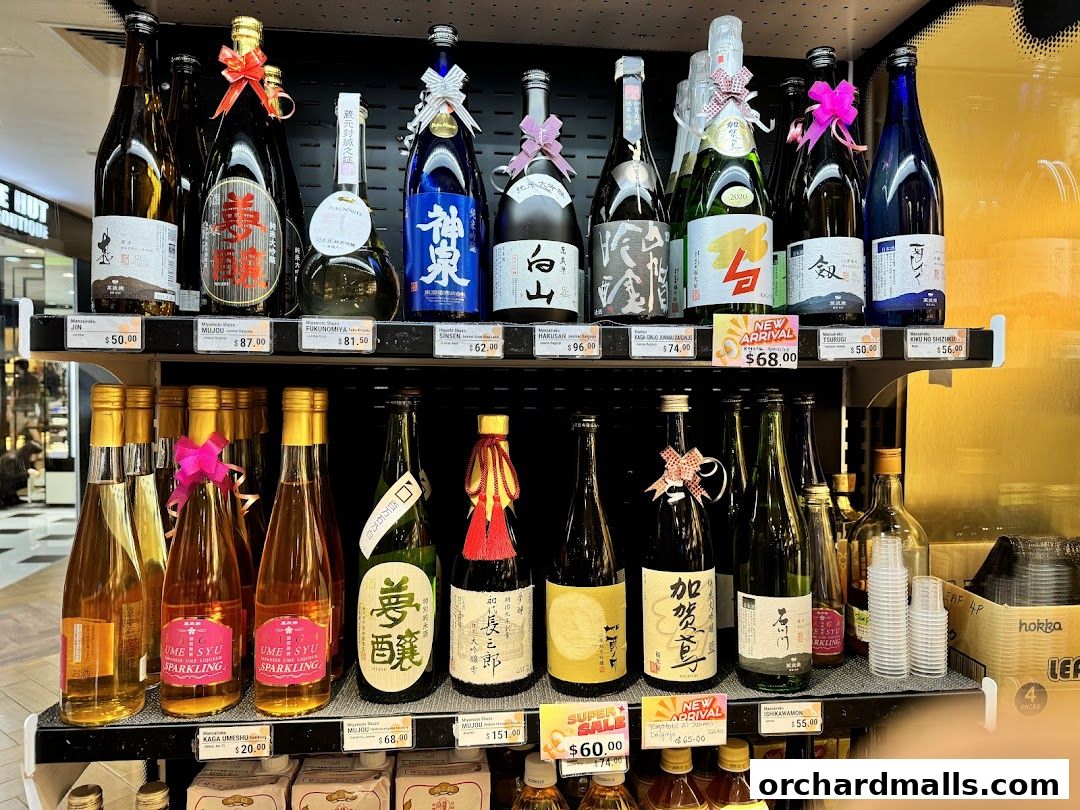 A display of various Japanese sake bottles and liquors on shelves, with prices visible.
