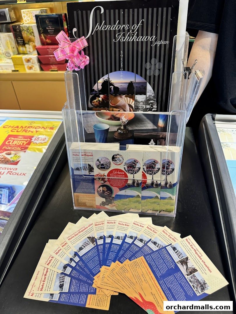 A display of brochures and products from 'Flavours of Ishikawa' with a focus on the Noto Earthquake.