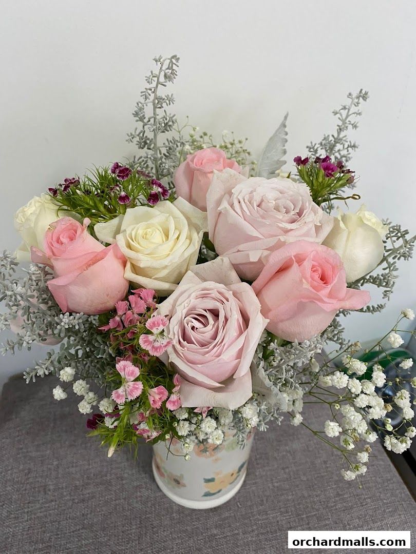 A beautiful arrangement of pink and white roses in a floral vase.