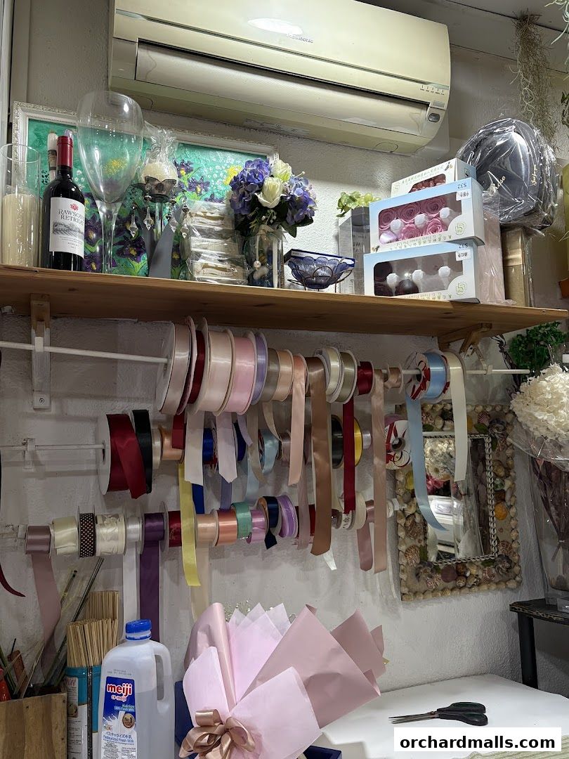 A display of floral arrangement supplies including ribbons, flowers, and gift boxes.