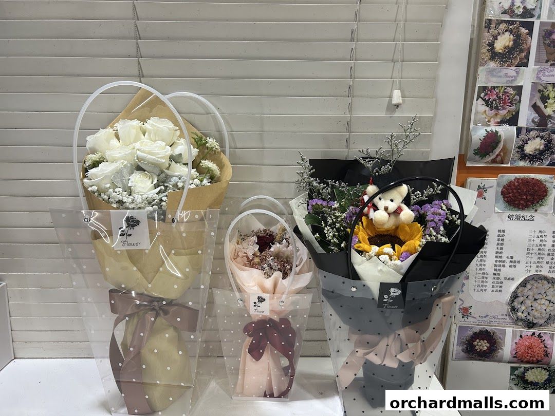 Beautifully arranged bouquets and floral arrangements displayed in clear packaging.