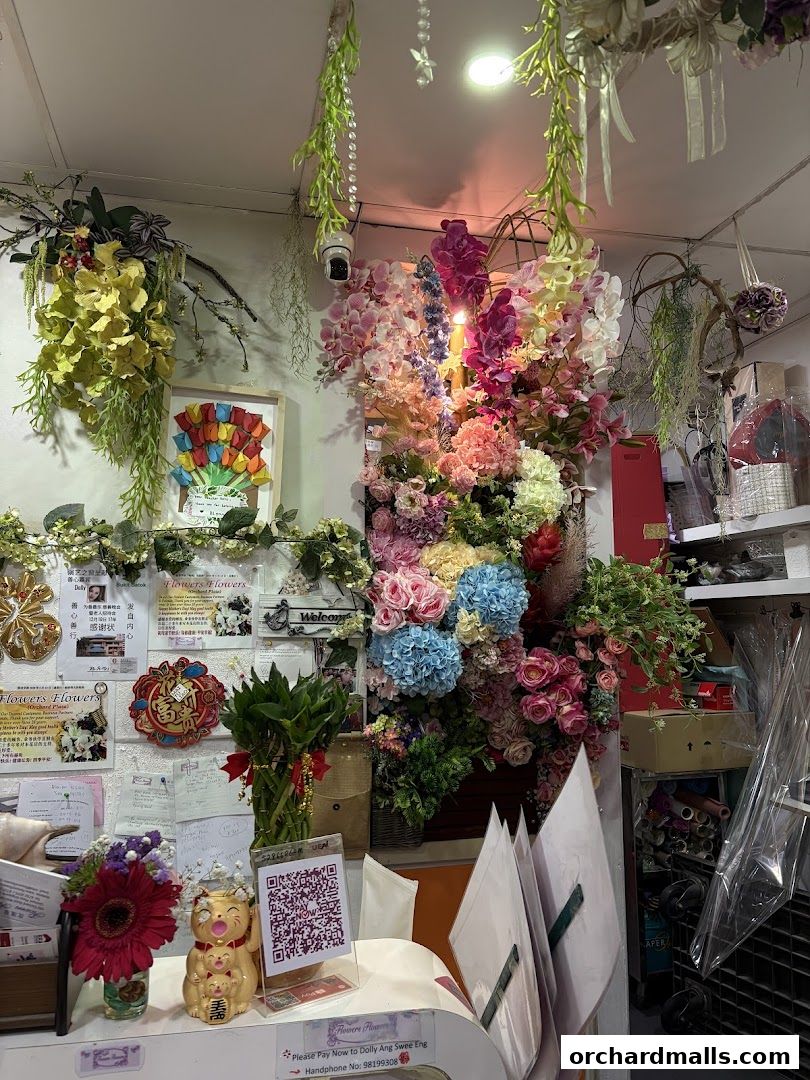 A vibrant flower shop interior filled with a colorful assortment of artificial flowers and decorative items.