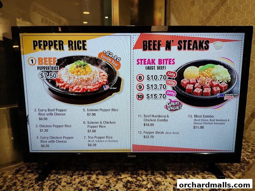 A digital menu displays Pepper Rice and Beef N' Steaks dishes with prices.