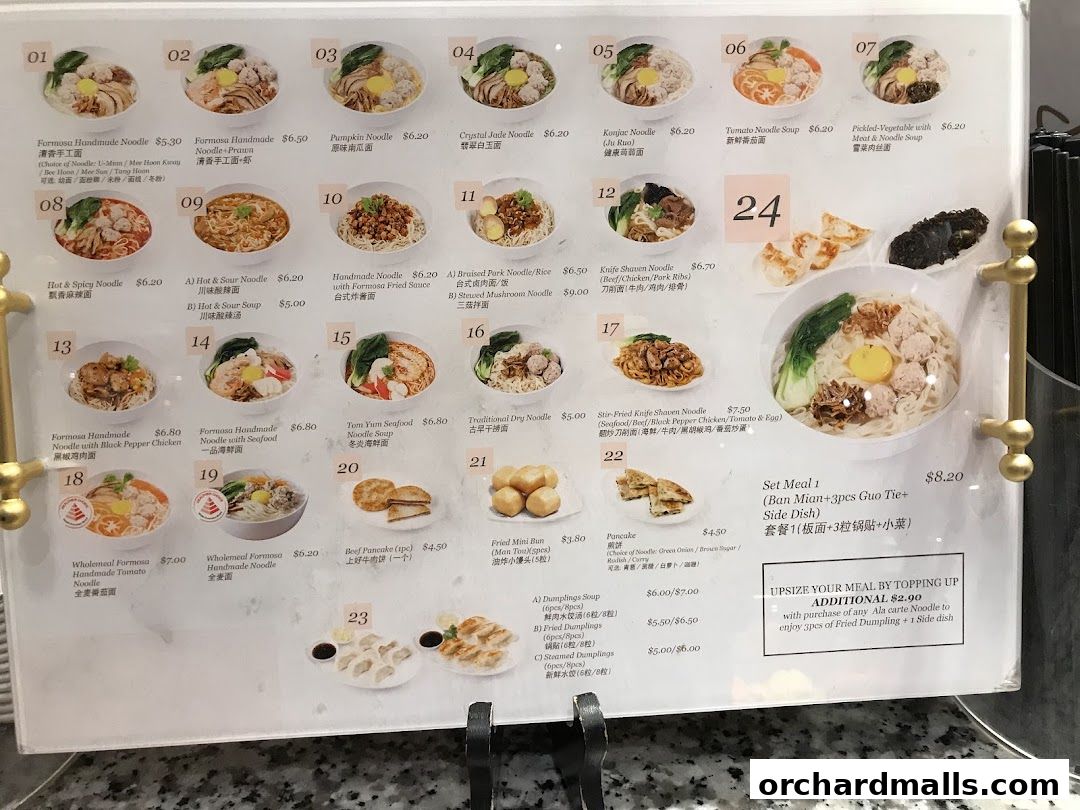 A menu board displaying various noodle dishes, soups, and set meals with prices and images.