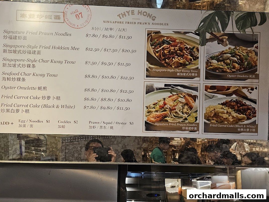 A menu board for Thye Hong Singapore Fried Prawn Noodles with pictures of dishes.