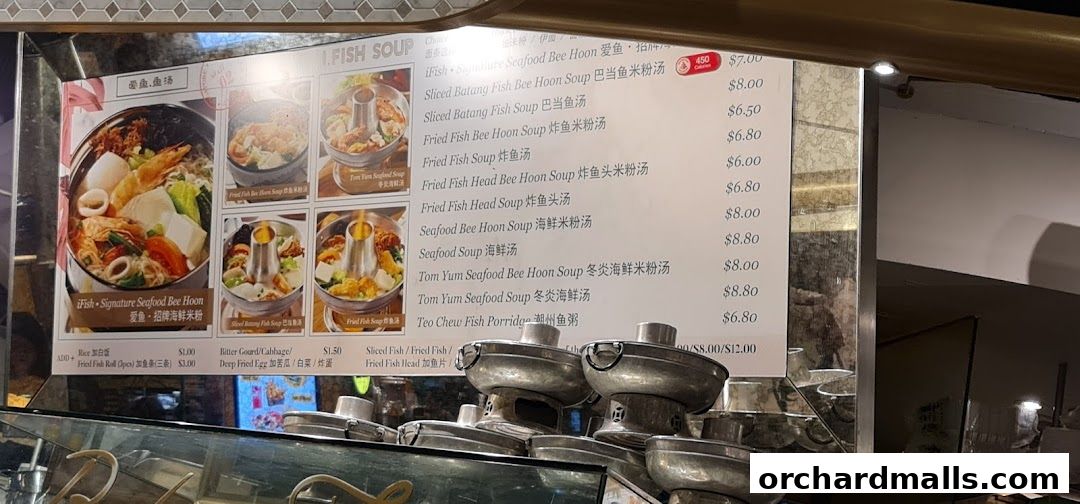 A menu board displays various fish soup and bee hoon dishes with prices and images.