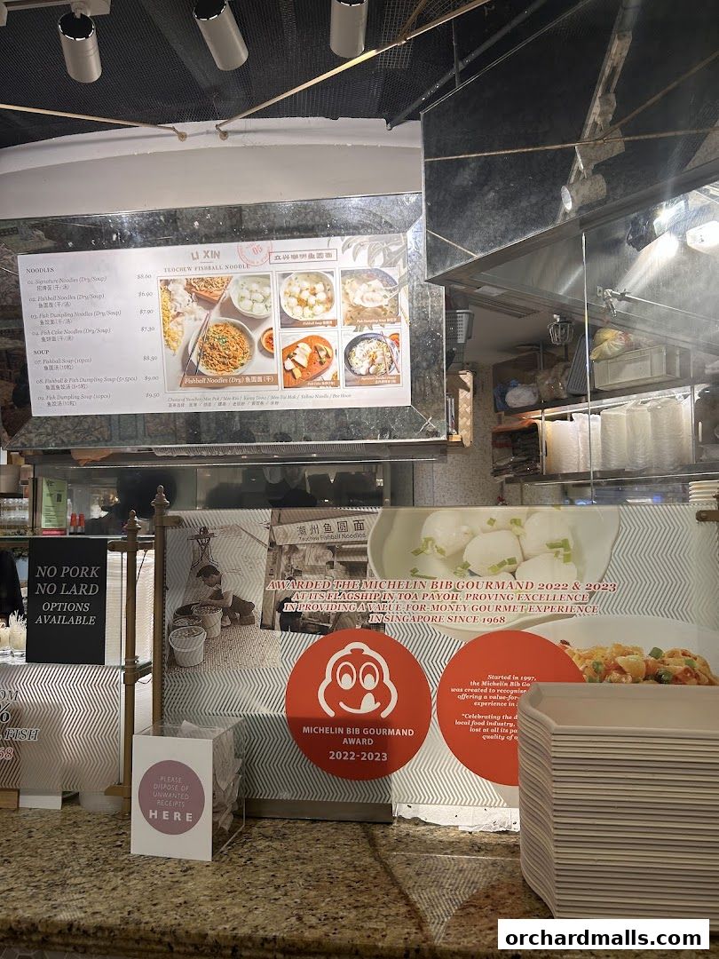 A menu board for Li Xin Teochew Fishball Noodle, featuring noodle and soup dishes with prices.