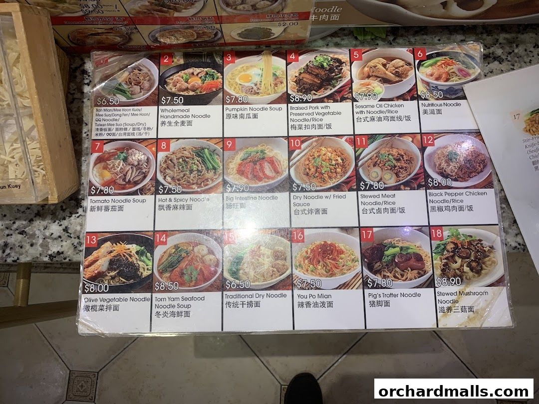 A menu displaying various noodle dishes with prices and descriptions in English and Chinese.
