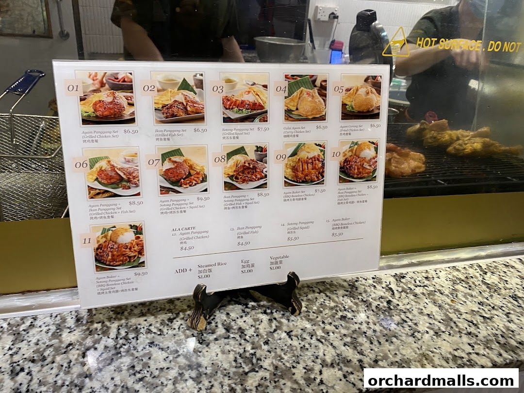 A menu board displays various grilled chicken, fish, and squid sets with prices.