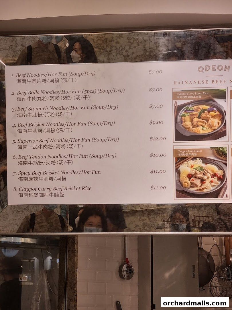 A menu board displaying various beef noodle dishes and claypot rice options.