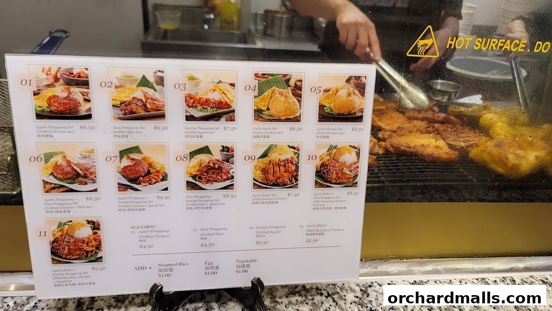 A menu board displaying various grilled chicken, fish, and squid sets with prices.