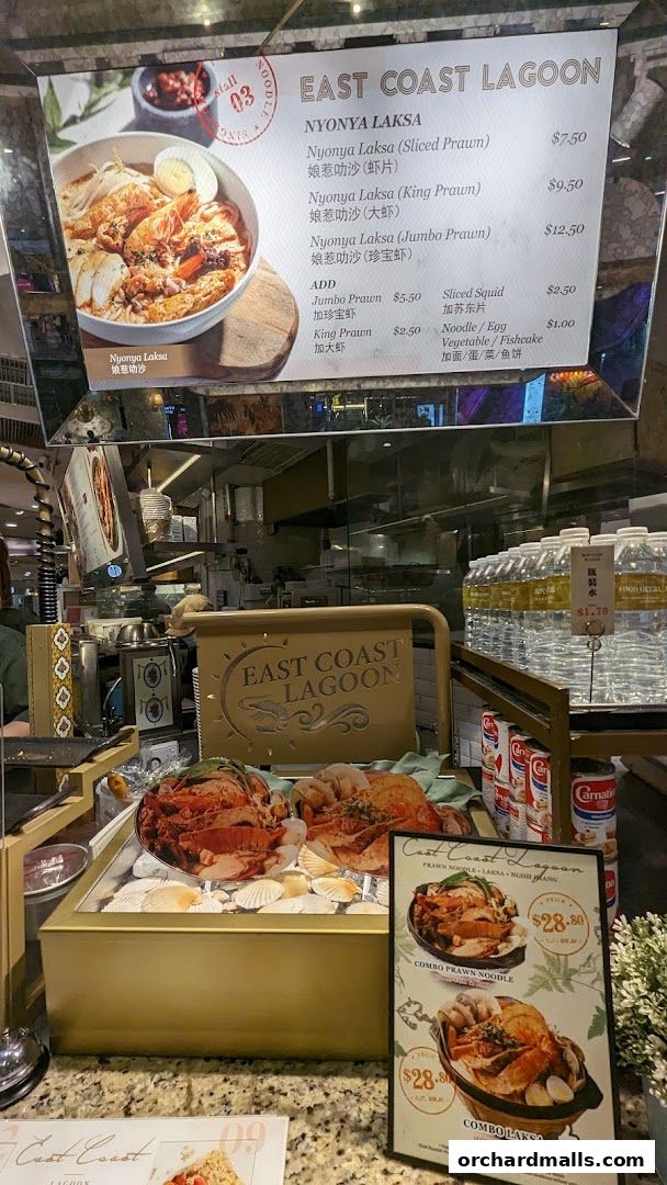 A menu display for East Coast Lagoon featuring Nyonya Laksa and combo meals.