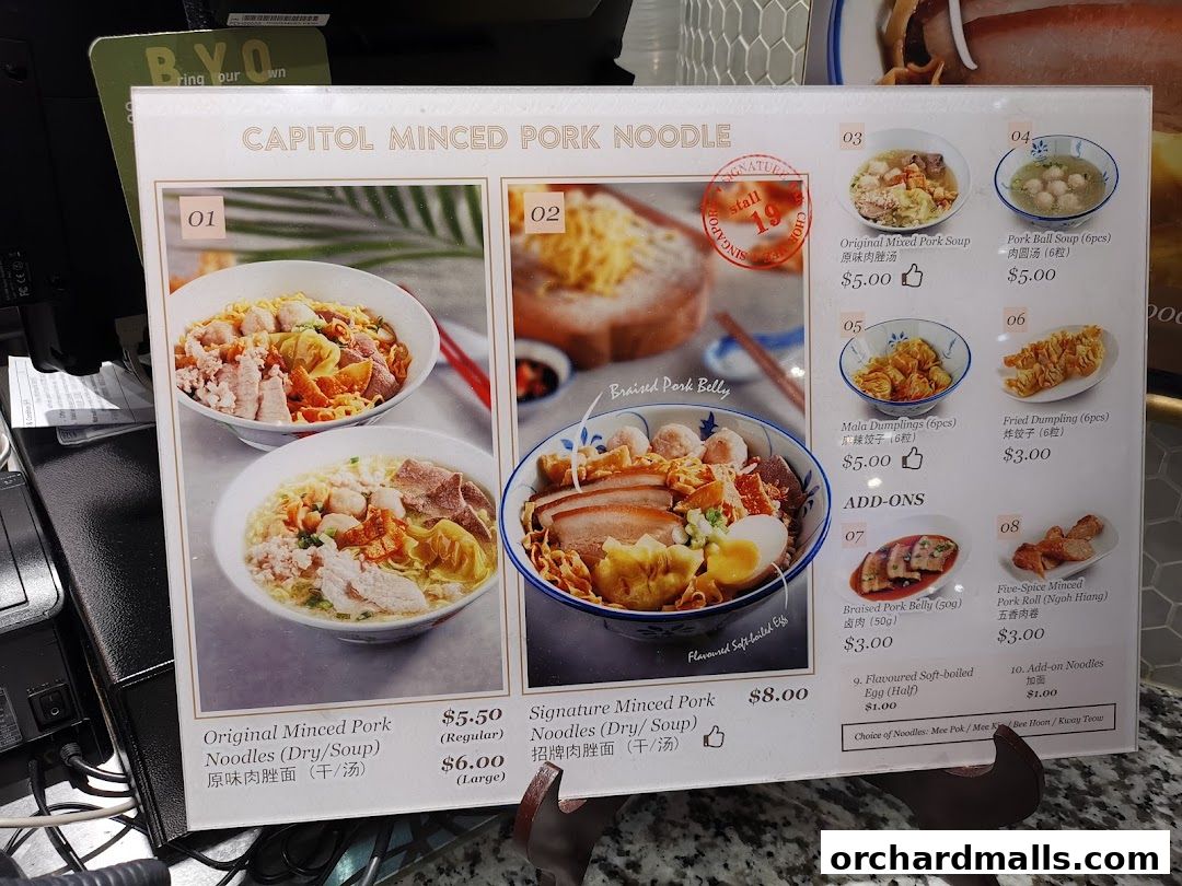 A menu board displaying various minced pork noodle dishes and add-ons with prices.