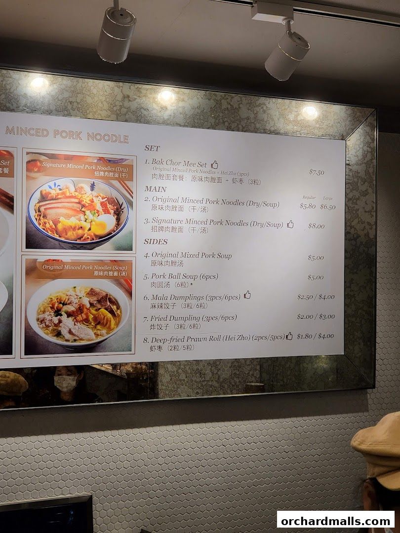 A menu board for Minced Pork Noodles with various main dishes and sides.